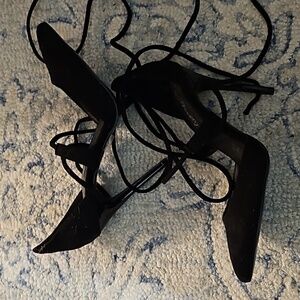 Black suede pointed toe stilettos that tie up the leg